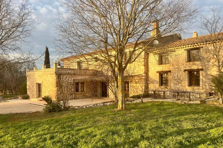 La bâtisse en pierre du domaine au soleil couchant